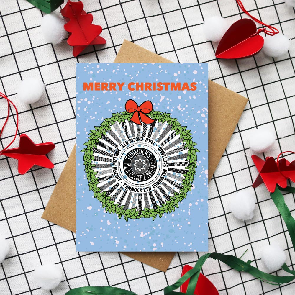 tunnocks tea cake on a Christmas card with a wreath around it